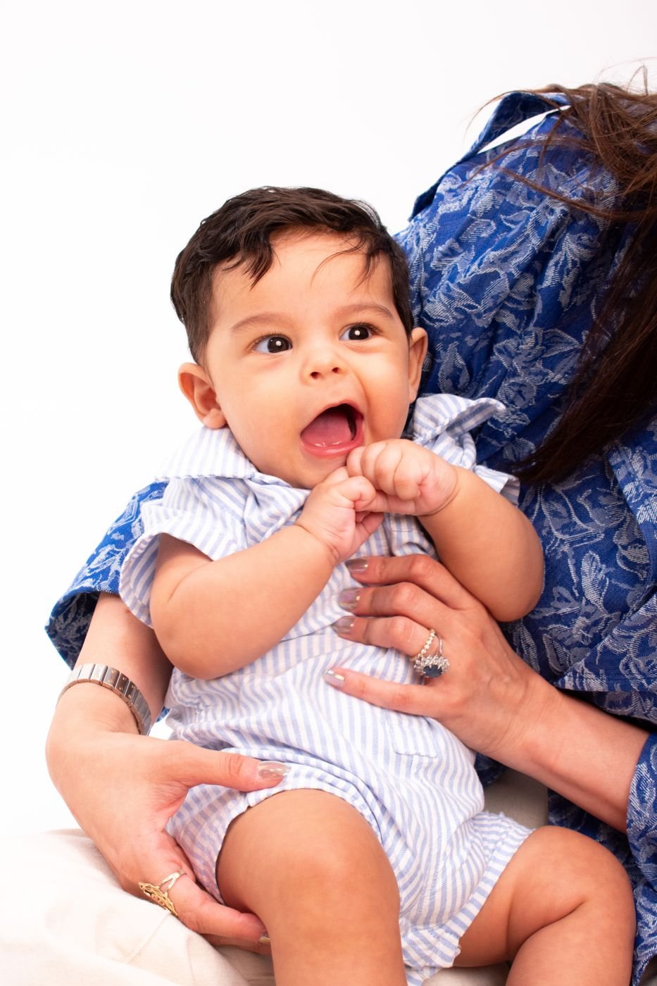 Baby laughing joyfully in a parent's arms