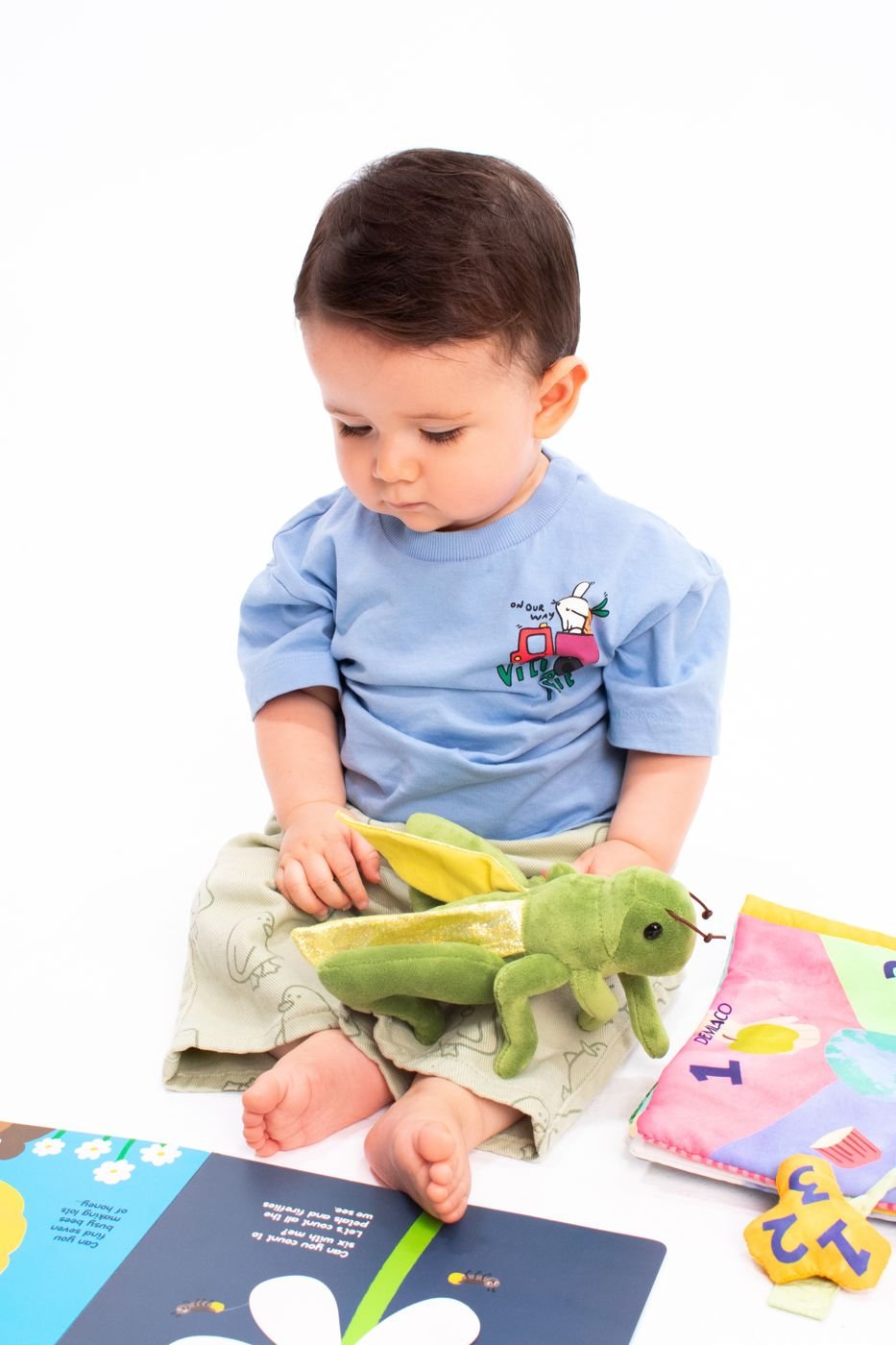 Baby engaged in independent play with a toy